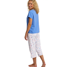 Load image into Gallery viewer, Woman wearing a blue top and patterned white pants on a white background
