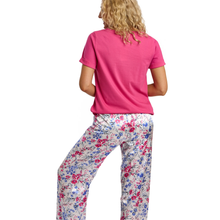 Load image into Gallery viewer, Woman wearing a pink shirt and floral pants on a white background
