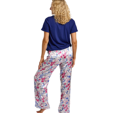 Load image into Gallery viewer, Woman wearing a blue top and floral pants on a white background
