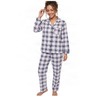 A woman modeling a two-piece pajama set with a blue, white, and gray plaid pattern against a plain white background.