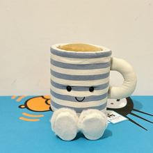 Load image into Gallery viewer, Plush toy shaped like a striped mug with a face on a blue surface
