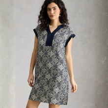 Load image into Gallery viewer, Woman wearing a patterned dress against a plain background
