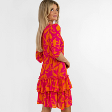 Load image into Gallery viewer, female model looking at camera showing back and side of pink and orange dress
