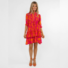 Load image into Gallery viewer, female model standing with arms to the side smiling wearing pink and orange dress
