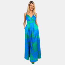 Load image into Gallery viewer, Female model standing in blue and green dress with hands in pockets.
