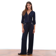 Load image into Gallery viewer, Woman wearing a navy blue jumpsuit with zippers on a white background
