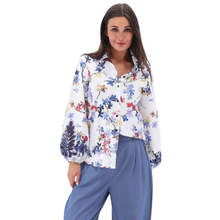 Load image into Gallery viewer, Woman wearing a floral blouse and blue pants on a white background
