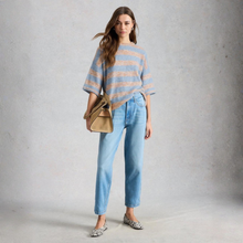 Load image into Gallery viewer, Full view of Model, wearing White Stuff Kate Knitted Stripe Tee, in a Natural Colour, with a grey background.
