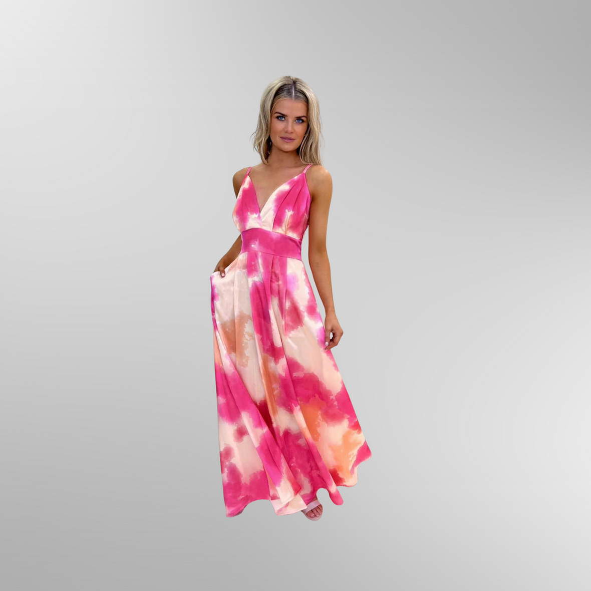 Model is posing in Kate and Pippa maxi dress Lola in pink. Dress has v-neckline and  strap sleeves.
