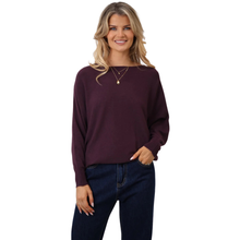Load image into Gallery viewer, Woman wearing a dark purple sweater and blue jeans on a white background
