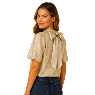 Woman wearing a beige blouse with a bow detail on a white background