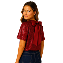 Load image into Gallery viewer, Woman wearing a red sequin top with a large bow on a white background
