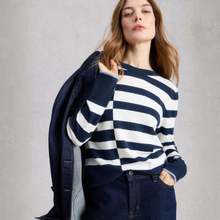 Load image into Gallery viewer, Woman wearing a navy and white striped sweater with a denim jacket over her shoulder against a plain background
