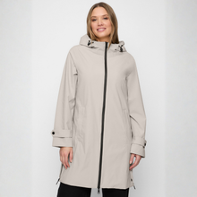 Load image into Gallery viewer, Woman wearing a beige raincoat with a black zipper on a white background
