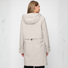 Load image into Gallery viewer, Woman wearing a beige hooded coat on a white background
