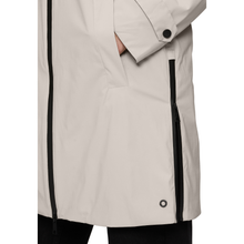 Load image into Gallery viewer, Close-up of a beige raincoat with black zipper and button details on a white background
