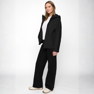 Woman wearing a black outfit with a white background