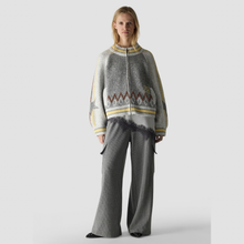 Load image into Gallery viewer, Lady in oversized cardigan paired with grey pants 
