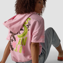 Load image into Gallery viewer, graffiti hoodie on lady seating with jeans 
