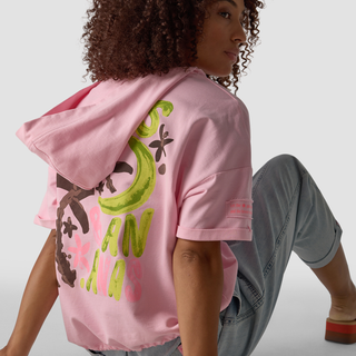 graffiti hoodie on lady seating with jeans 