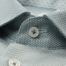 Load image into Gallery viewer, Close-up of a collared dress shirt with a fine textured weave in light blue and white, featuring a white button at the collar.
