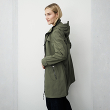 Load image into Gallery viewer, Woman wearing a green parka against a white background
