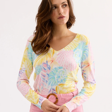 Load image into Gallery viewer, Woman wearing a colorful tie-dye long-sleeve shirt with a plain background
