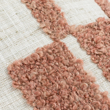 Load image into Gallery viewer, Close-up of a textured area rug with chunky, looped dusty rose and terracotta geometric shapes on a cream woven background.
