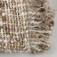 Load image into Gallery viewer, Close-up of a textured fabric with natural color palette on a white background
