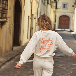 Woman in logo sweater on street