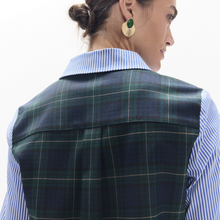 Load image into Gallery viewer, A woman shown from the back wearing a navy and green plaid vest over a light blue and white striped collared shirt, with a white studio background.
