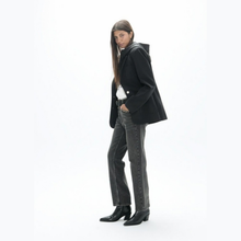 Load image into Gallery viewer, Side view of jacket on model paired with jeans 
