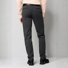 Load image into Gallery viewer, Rear view of a person wearing dark charcoal gray slim-fit trousers, a light peach long-sleeve top, a black belt, and black shoes, standing against a light gray studio background.
