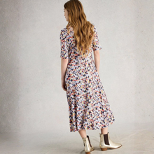 Load image into Gallery viewer, Woman wearing a floral dress and gold boots against a plain background

