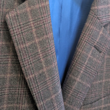 Load image into Gallery viewer, Close-up of a textured brown and gray checkered jacket with a blue lining.
