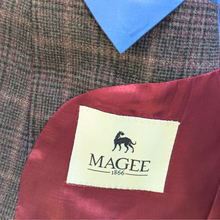 Load image into Gallery viewer, Close-up of a Magee label on a suit with a plaid pattern and red fabric.
