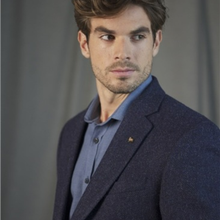 Load image into Gallery viewer, Man wearing a dark blue suit with a light gray background
