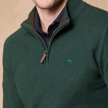 Load image into Gallery viewer, A close-up of a man wearing a dark green quarter-zip knit sweater with a small embroidered moose logo on the chest, layered over a navy collared shirt.
