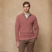 Load image into Gallery viewer, Man wearing a pink sweater over a light shirt with brown pants against a beige background
