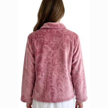 Load image into Gallery viewer, A woman viewed from the back wearing a dusty pink fleece jacket with an embossed damask pattern, set against a plain white background.
