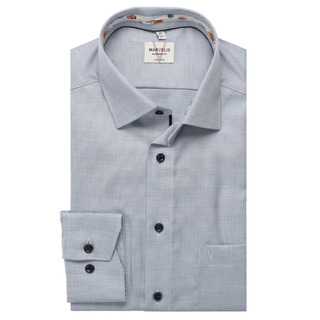 Folded light blue shirt with a visible brand label on a white background