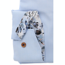 Load image into Gallery viewer, Light blue baby blanket with a floral ribbon and wooden button on a white background
