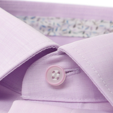 Load image into Gallery viewer, Close-up of a light purple shirt with a button, on a matching purple background.
