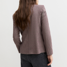 Load image into Gallery viewer, A woman shown from the back wearing a long-sleeve blazer with a fine brown and white gingham pattern, paired with dark gray jeans, against a plain white studio background.
