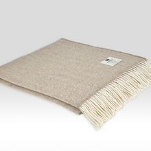 Load image into Gallery viewer, Beige woven blanket with white fringe on a light gray background
