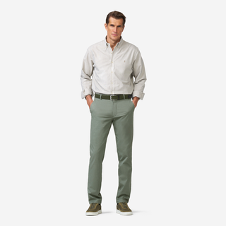 Man wearing a light gray shirt and green pants on a white background