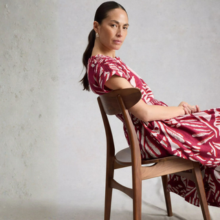 Lady on chair in printed dress 