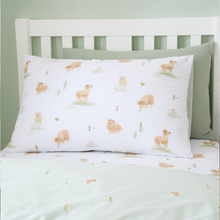 Load image into Gallery viewer, cow-patterned pillowcase and sheet set on a bed with a green wall background

