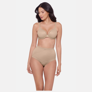 Woman wearing a beige bra and panties set on a white background