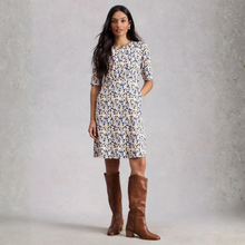 Load image into Gallery viewer, Woman wearing a floral dress and brown knee-high boots against a plain background
